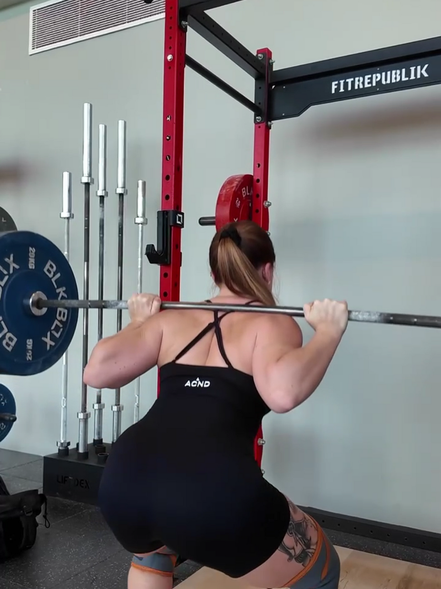 Ascend Active black unitard stay-put fit during heavy squats in the gym